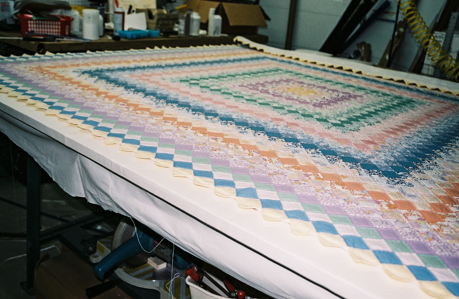 Quilt on stretcher frame as it is being hand sewn to fabric backing